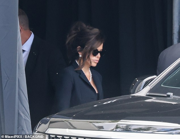 Bezos's new wife Lauren was seen in a pearl necklace and black sunglasses with a demure, formal black dress and blazer
