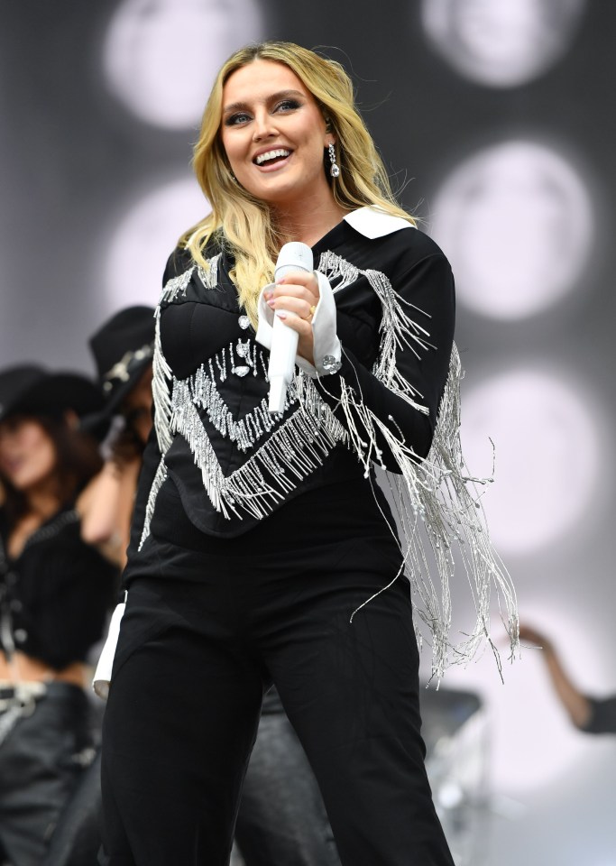 Perrie Edwards performing at a music festival.