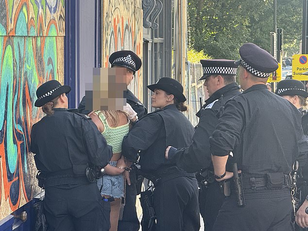 According to a friend, she allegedly threw a glass bottle of alcohol at police