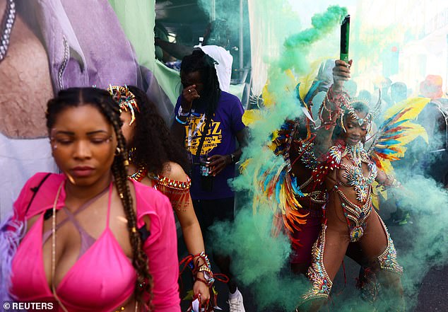 Women wear detailed and flamboyant outfits as a part of the celebrations in the west London district