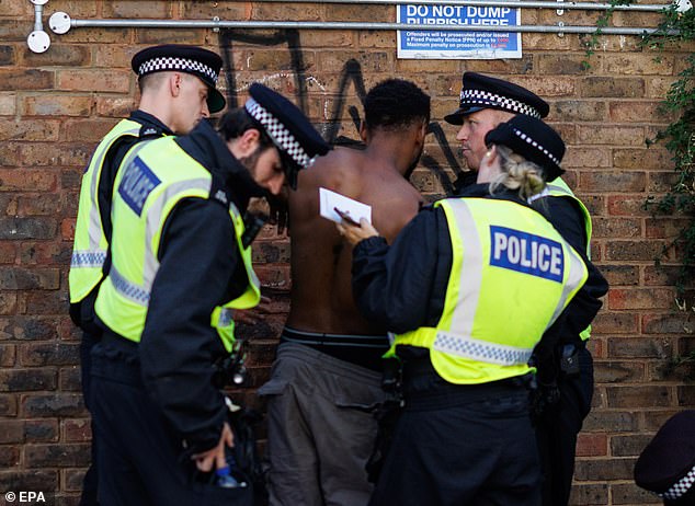 Police officers make an arrest during the Notting Hill Carnival in London, on Monday, August 25, 2025