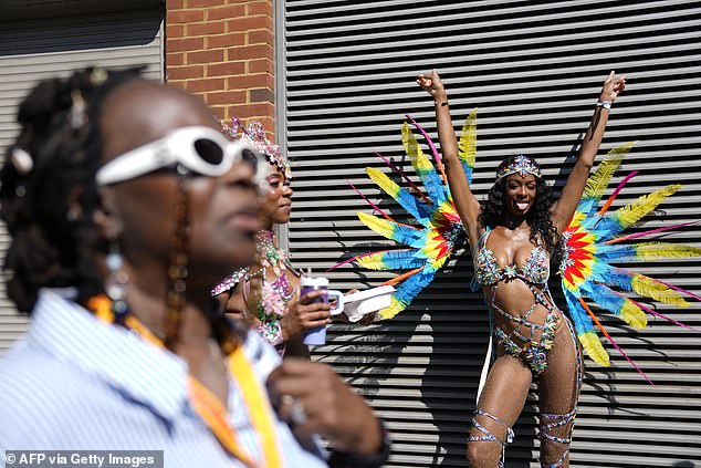 Another woman strikes a pose as she flaunts her multi-coloured carnival attire