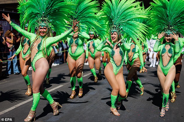 A group dance in green costumes for the Notting Hill Carnival on Monday