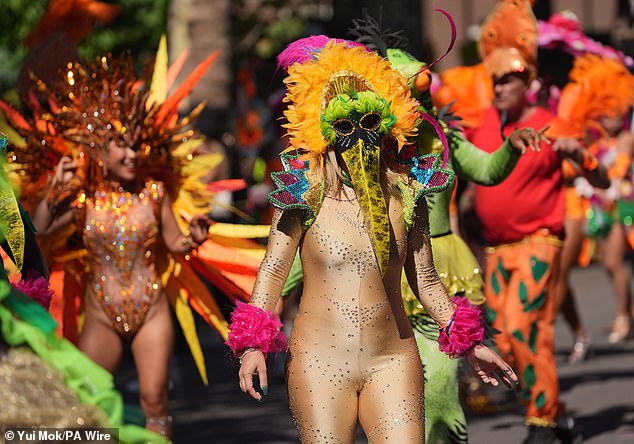 A person attends the event in an orange, pink, green and blue costume on Monday afternoon