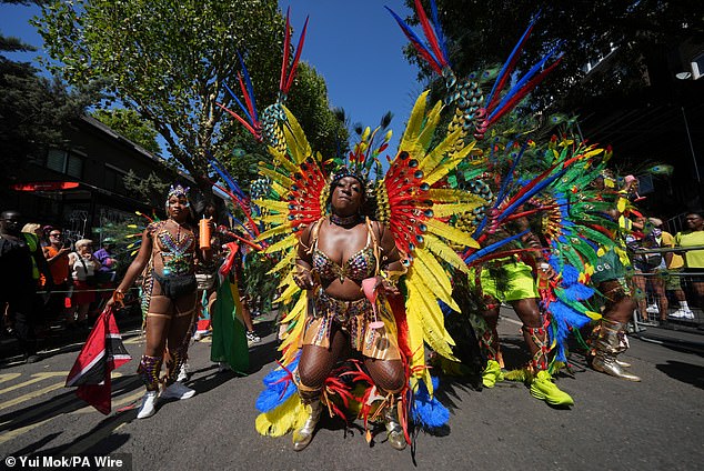Dancers take part in today's festival in the west London district in celebration of Caribbean culture