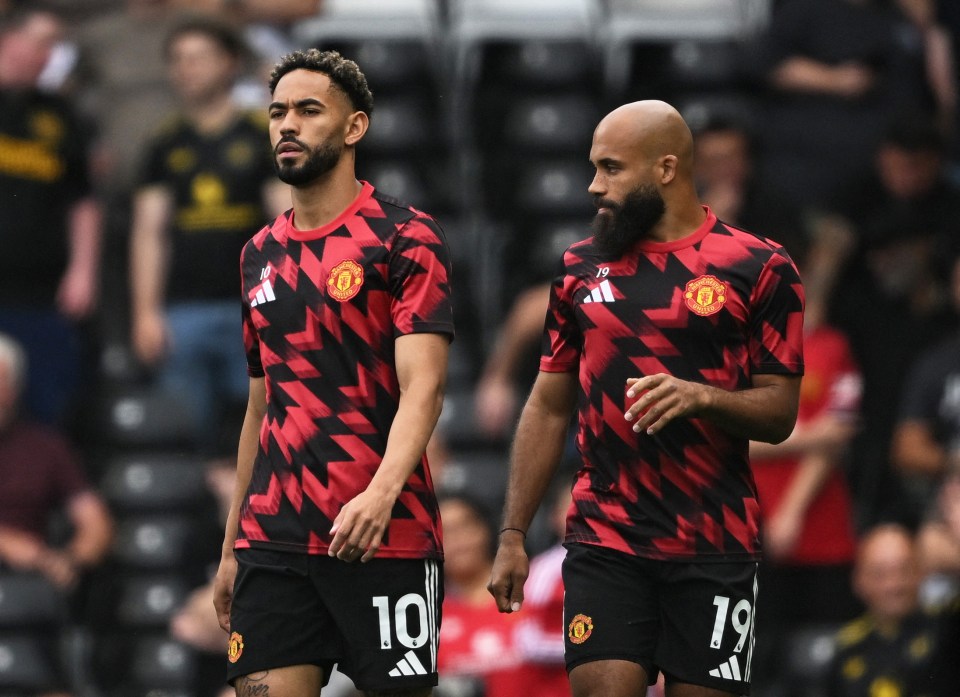 Matheus Cunha and another Manchester United player warming up.