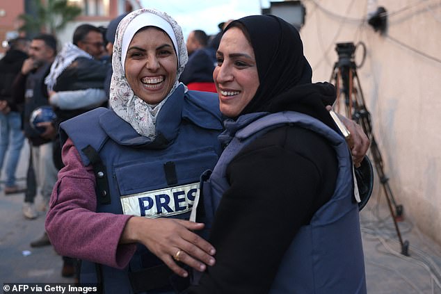 Mariam Dagga (L), a Palestinian visual journalist who freelanced for AP since the start of the war, hugs a fellow journalist in Khan Yunis in the southern Gaza Strip on January 18, 2025