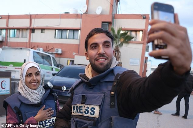 Moaz Abu Taha, a Palestinian journalist who had worked with some Palestinian and international outlets, takes a selfie with Mariam Dagga, a Palestinian visual journalist who freelanced for AP since the start of the war, in Khan Yunis in the southern Gaza Strip on January 18, 2025