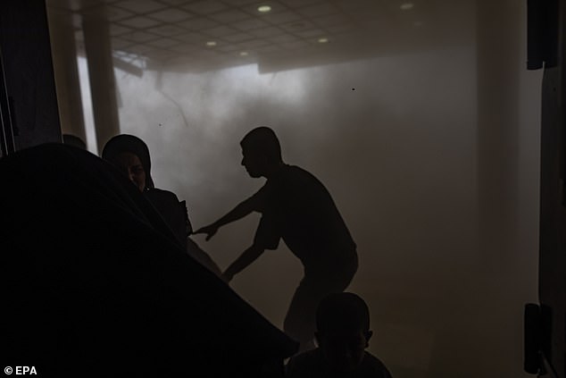 Palestinians flee following an Israeli airstrike targeting Nasser Hospital in Khan Younis, southern Gaza Strip, August 25 2025