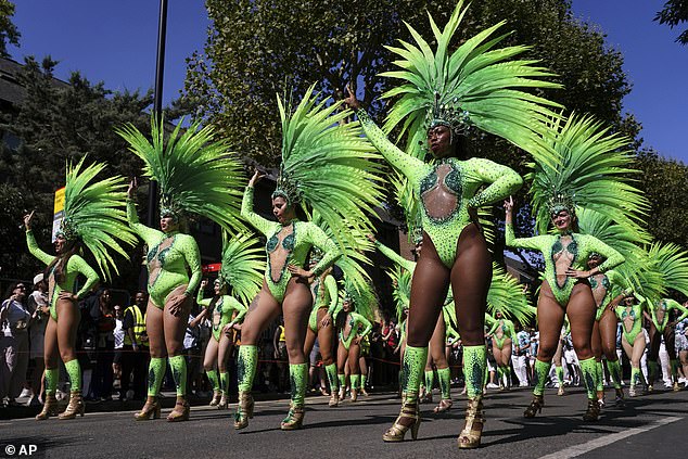 Revellers displayed their bright green outfits during in the carnival parade this afternoon