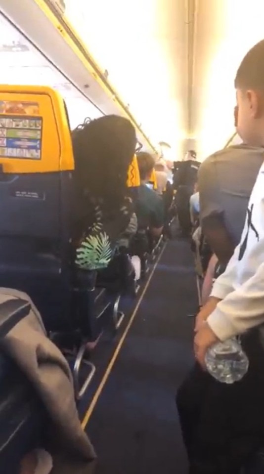 Police officers boarding a Ryanair plane.