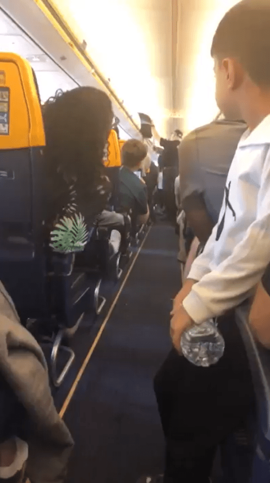 Police officers boarding a Ryanair plane.