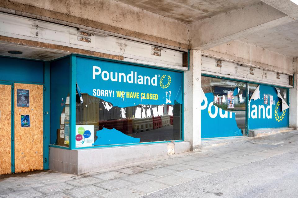 Closed Poundland store with damaged windows.