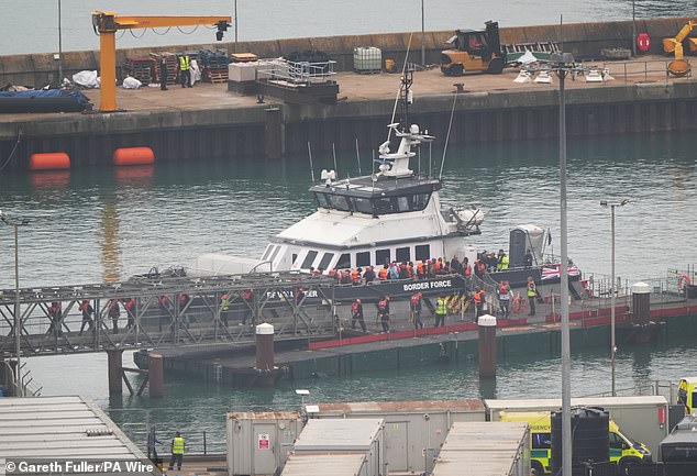 A group of people thought to be migrants are brought in to the Border Force compound in Dover, Kent, from a Border Force vessel following a small boat incident in the Channel (pictured)