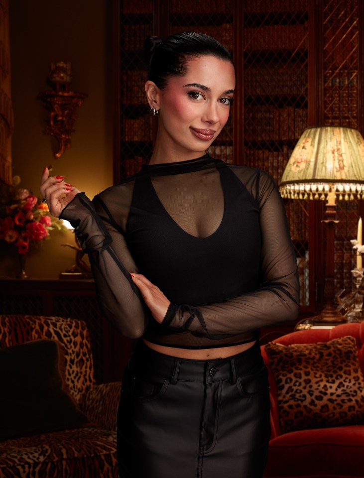 Woman in black sheer top and leather skirt.