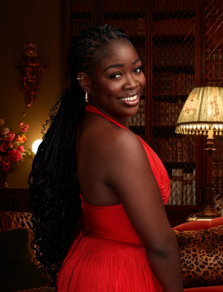 Portrait of a smiling Black woman in a red dress.