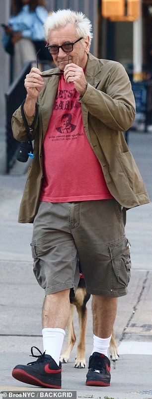 His summer look consisted of a red 'Beefsteak Charlie' shirt and Nike trainers