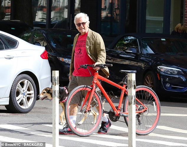 Griffin wheeled his bright red bike across the street