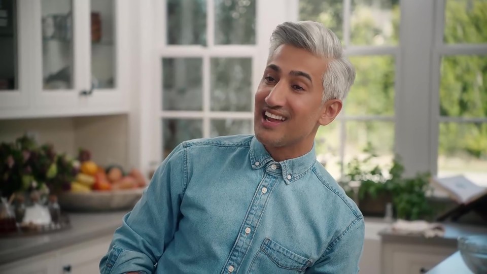 Tan France in a denim shirt.