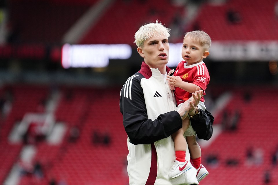Alejandro Garnacho of Manchester United holding a toddler.