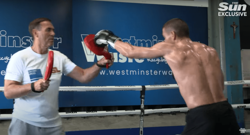 Boxer training with a coach.