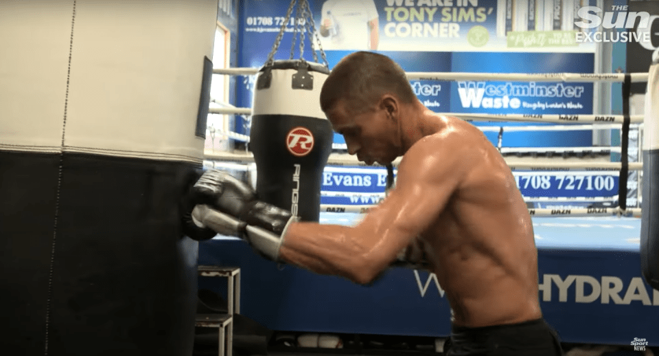 Boxer training with punching bag.