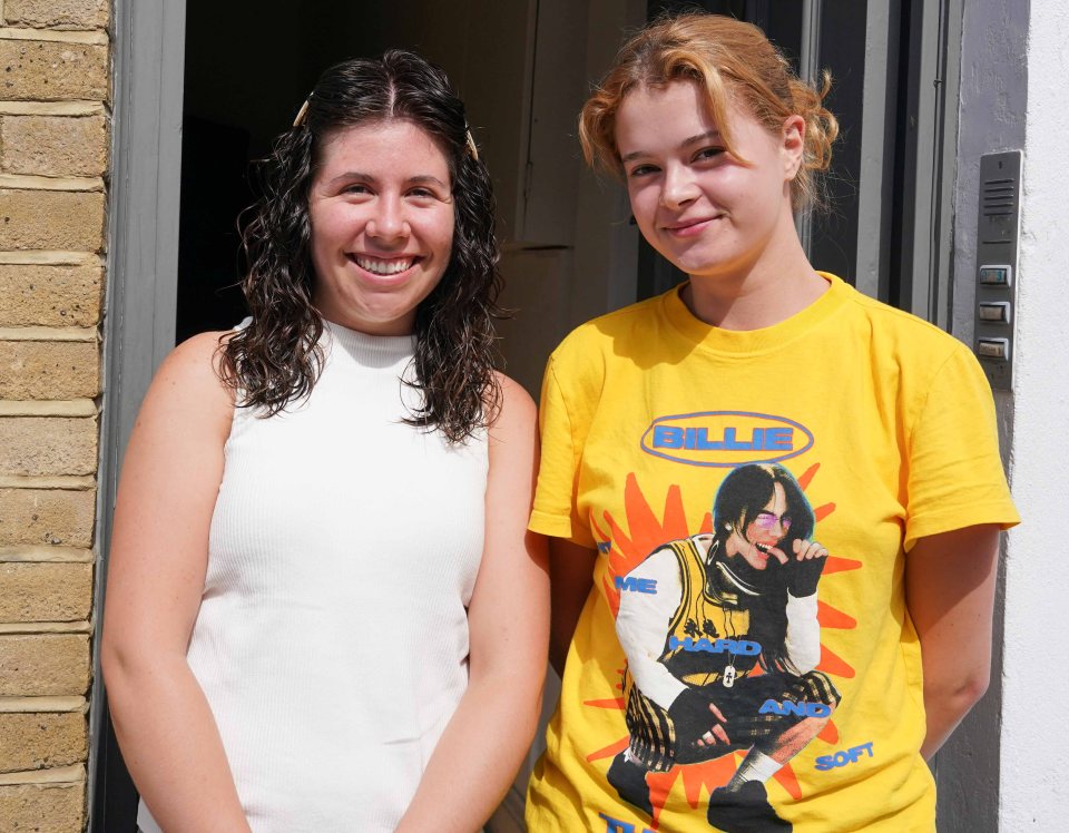 Two women standing near a doorway.
