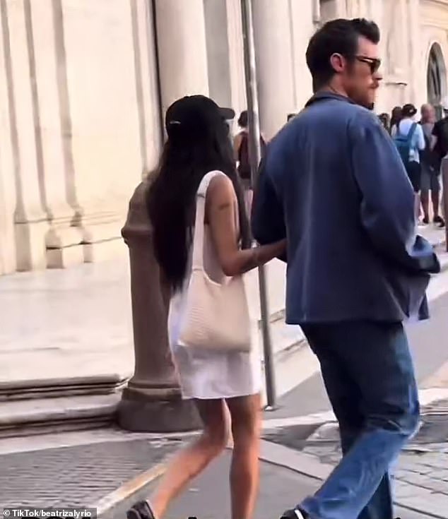 The pair were pictured enjoying a romantic stroll in Italy on Sunday, during which they walked together arm in arm (pictured)