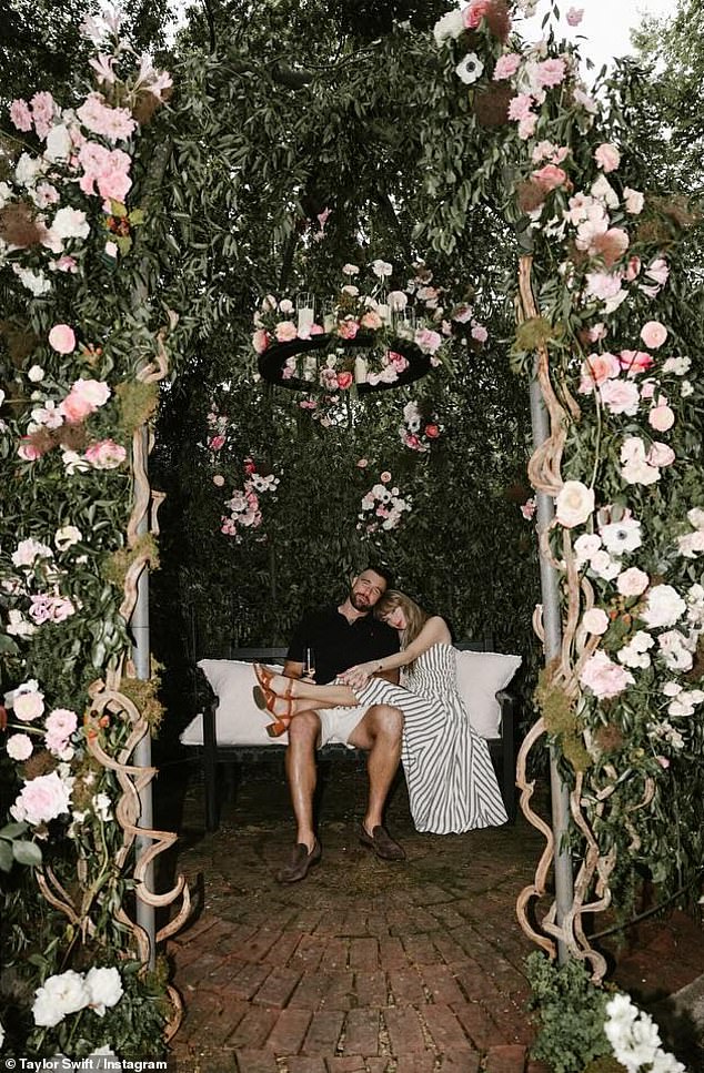 Swift slung her legs over Kelce as the pair celebrated their engagement with a glass of champagne