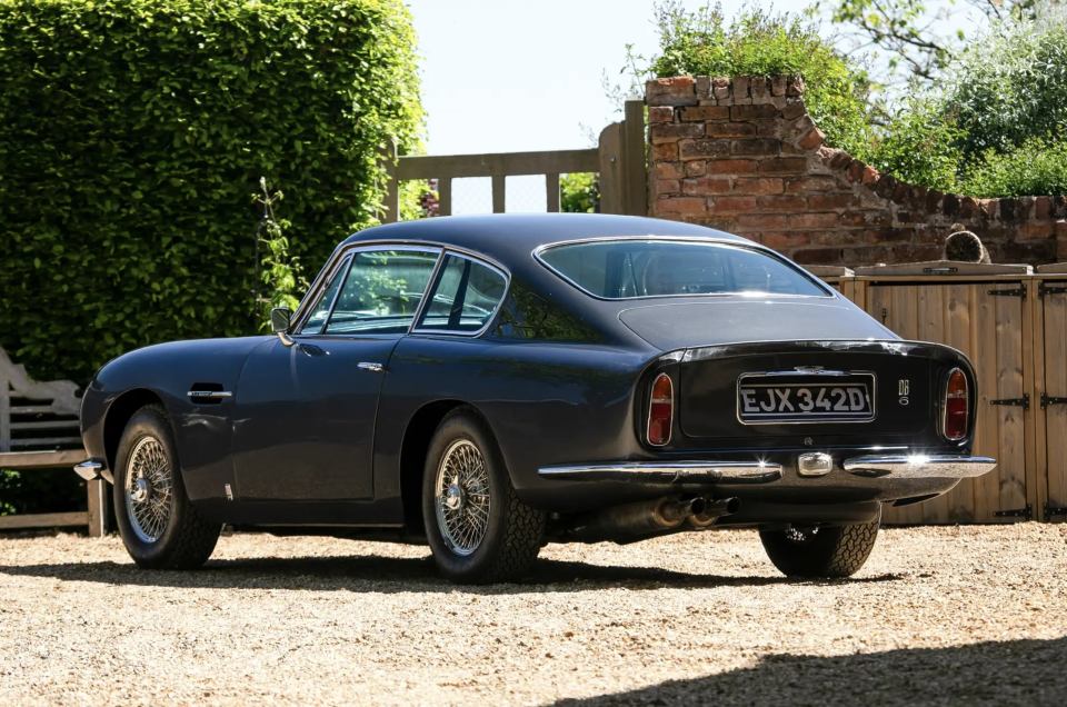 Rear view of a dark gray 1966 Aston Martin DB6 Mk1 Vantage.