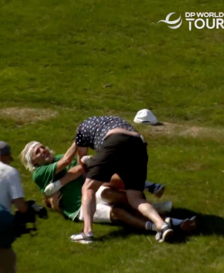 Two men wrestling on the ground.