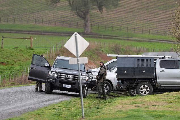 Armed police amid a search underway for an armed fugitive who the police said shot two police officers, at Feathertop Winery in Porepunkah, Australia, August 27, 2025. Simon Dallinger/AAP Image/via REUTERS    ATTENTION EDITORS - THIS IMAGE WAS PROVIDED BY A THIRD PARTY. NO RESALES. NO ARCHIVE. AUSTRALIA OUT. NEW ZEALAND OUT. NO COMMERCIAL OR EDITORIAL SALES IN NEW ZEALAND. NO COMMERCIAL OR EDITORIAL SALES IN AUSTRALIA.