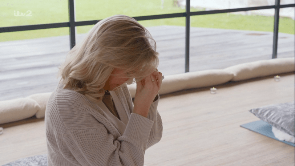 Woman sitting with head in hands.
