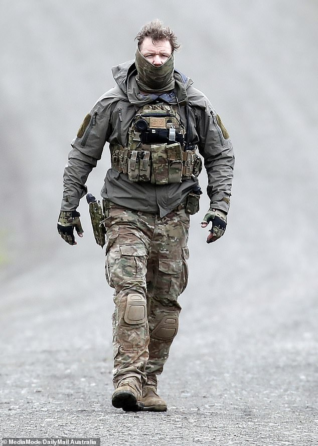 A Special Operations Group officer prepares to enter the wilderness to take down Freeman
