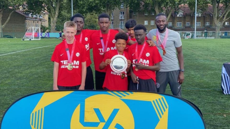 Team Newham youth soccer team with their trophy and medals.