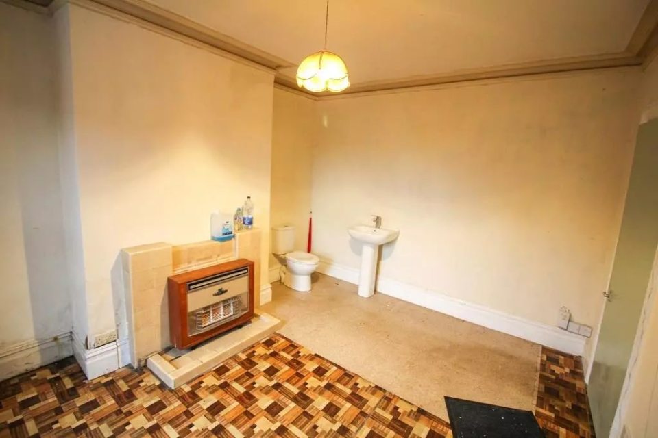 Living room with toilet and sink.