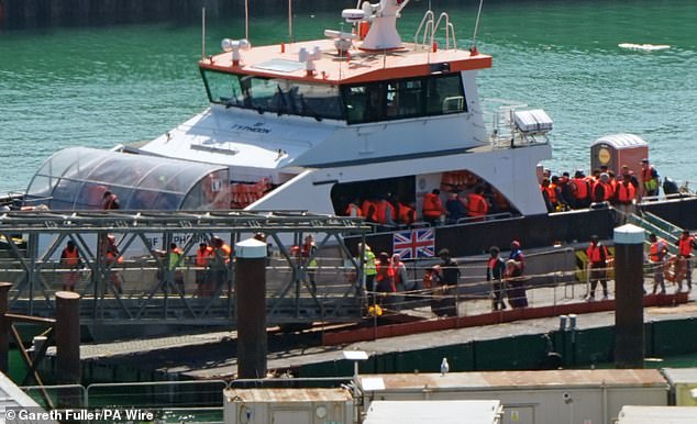 A group of people thought to be migrants being brought to the Border Force compound in Dover Kent, on August 11, 2025