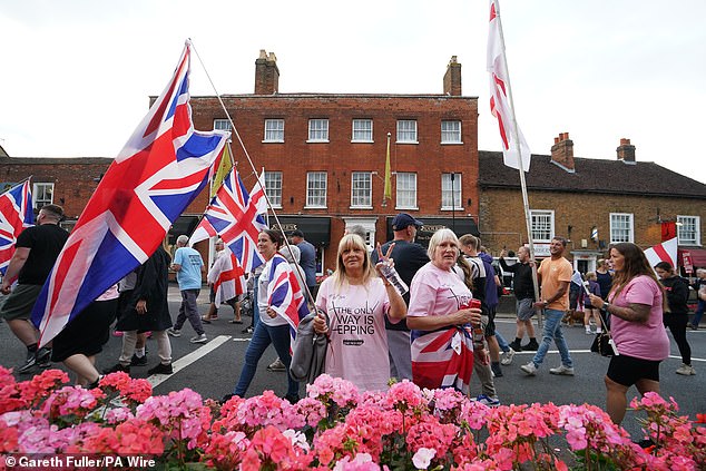 People in protesting under the Abolish Asylum System slogan in Epping town centre on August 24, 2025
