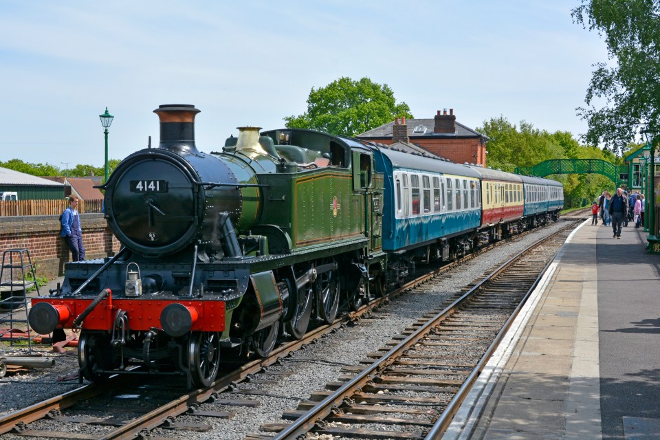 DNR141 Steam tank engine locomotive 4141 & passenger train at platform on Epping and Ongar preserved heritage railway at North Weald station Essex England UK