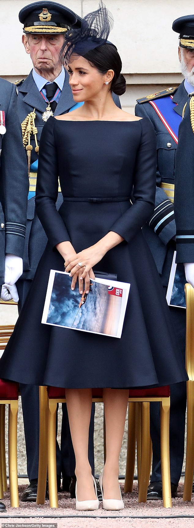 Meghan stepped out in a navy tailored frock which she paired with pantyhose while attending an RAF event in 2018