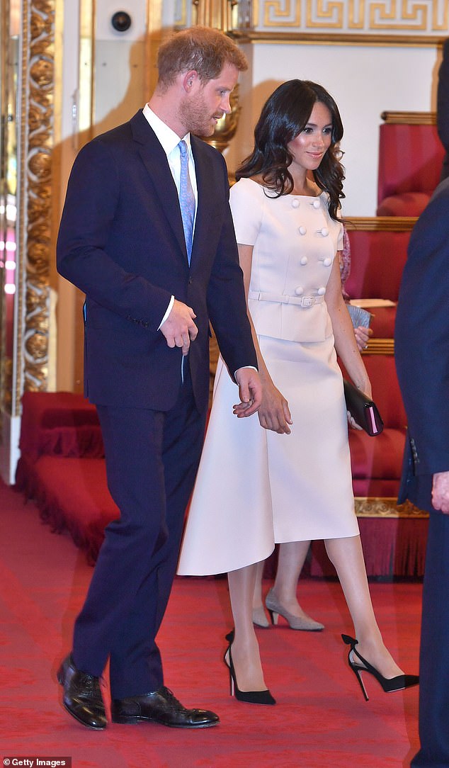 The Duchess of Sussex is seen wearing nude tights during the Queen's Young Leaders Awards Ceremony at Buckingham Palace in 2018