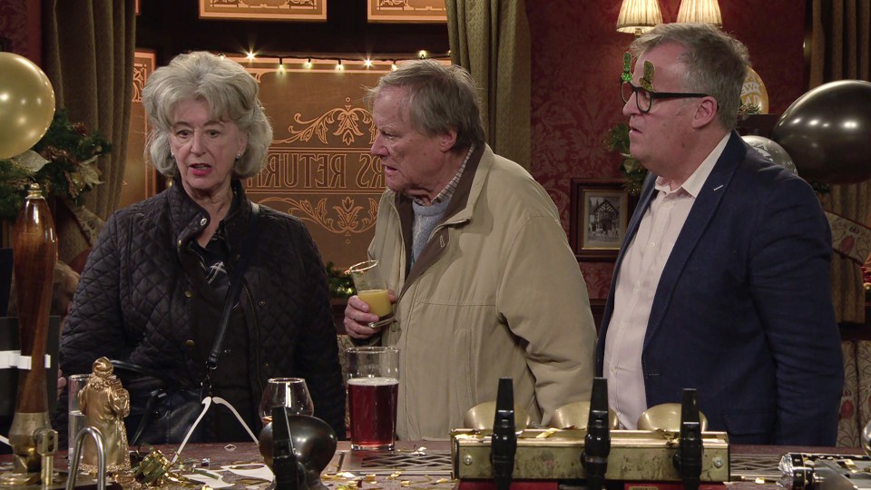 Evelyn Plummer, Roy Cropper, and another man at a bar in Coronation Street.