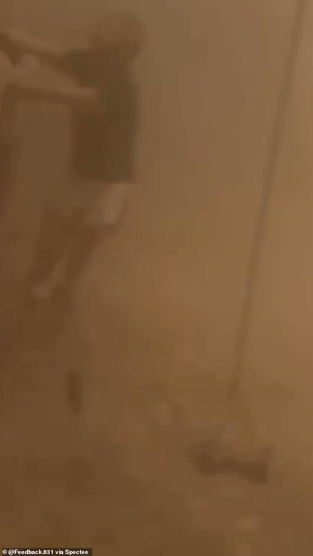 'Thunderstorm approaching the event site from the north. Light precipitation is currently falling in BRC. Possible strong winds in the next 20 minutes. Take care of your camps, and let your neighbors know,' officials said. Pictured: A man is barely visible in the dust storm