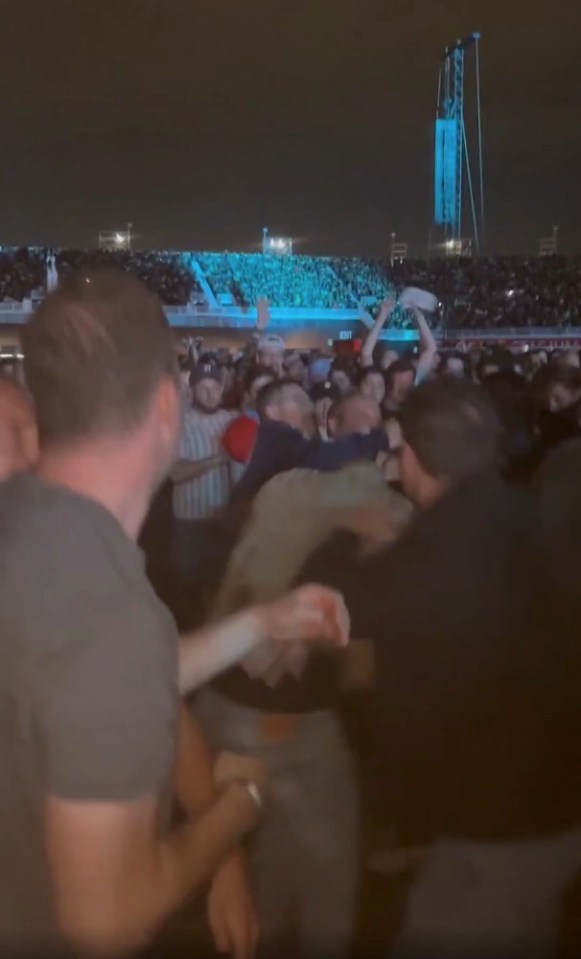 Fight breaking out in the crowd at an Oasis concert.