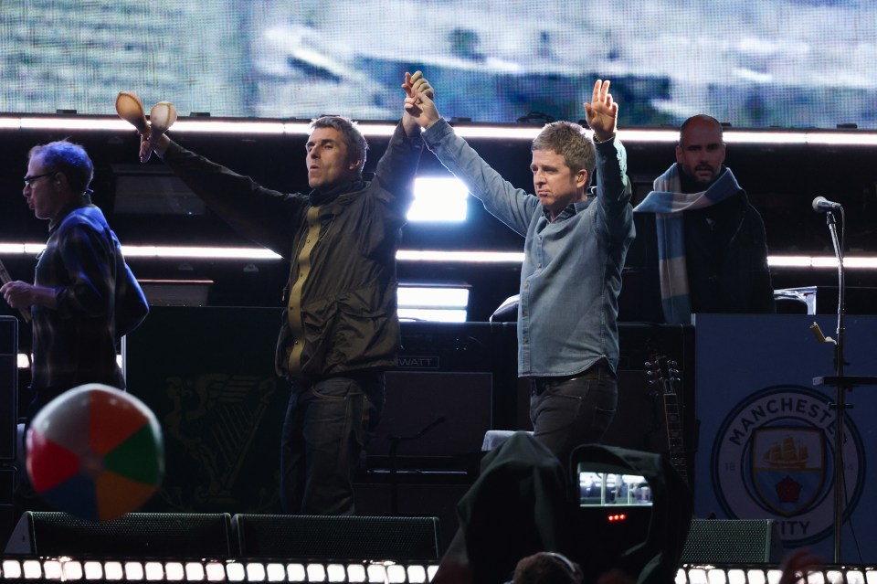 Liam and Noel Gallagher performing onstage.