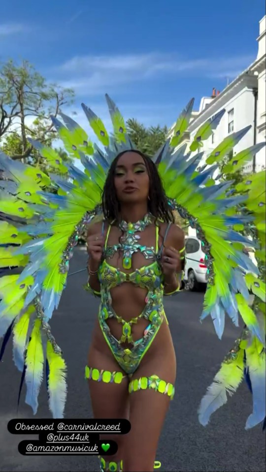 Woman in elaborate lime green and blue Carnival costume.