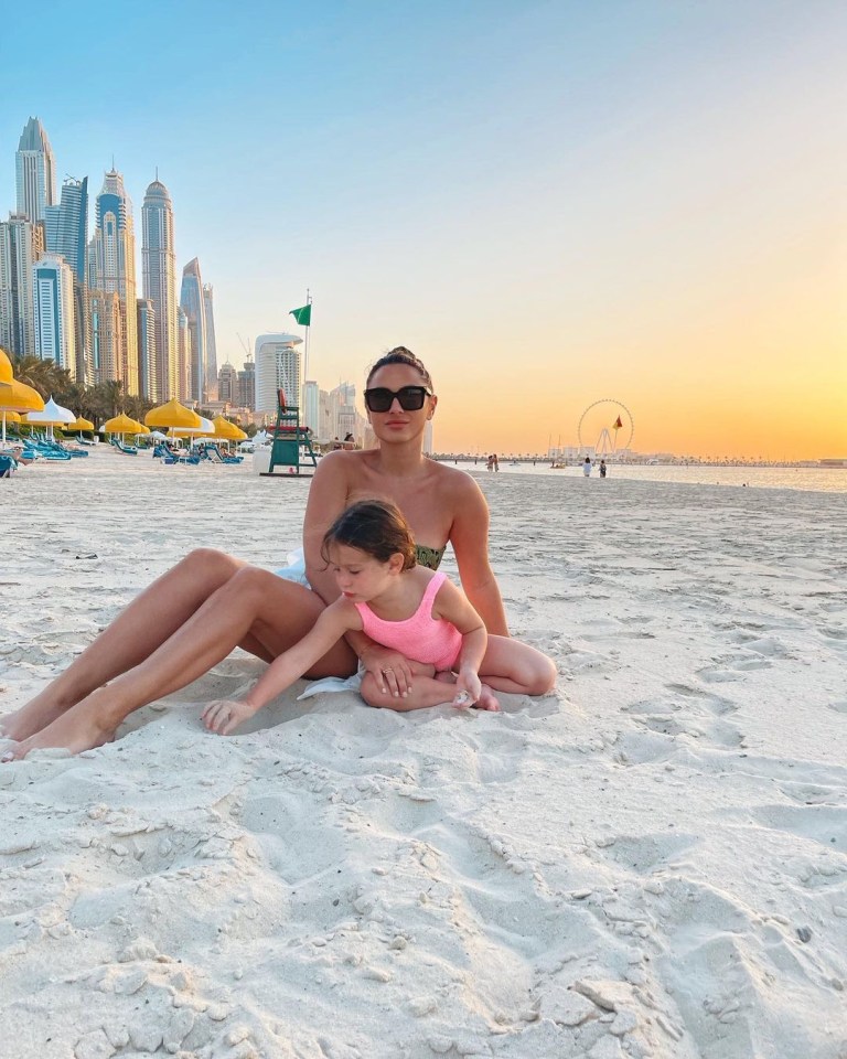 Woman and child on a beach in Dubai.