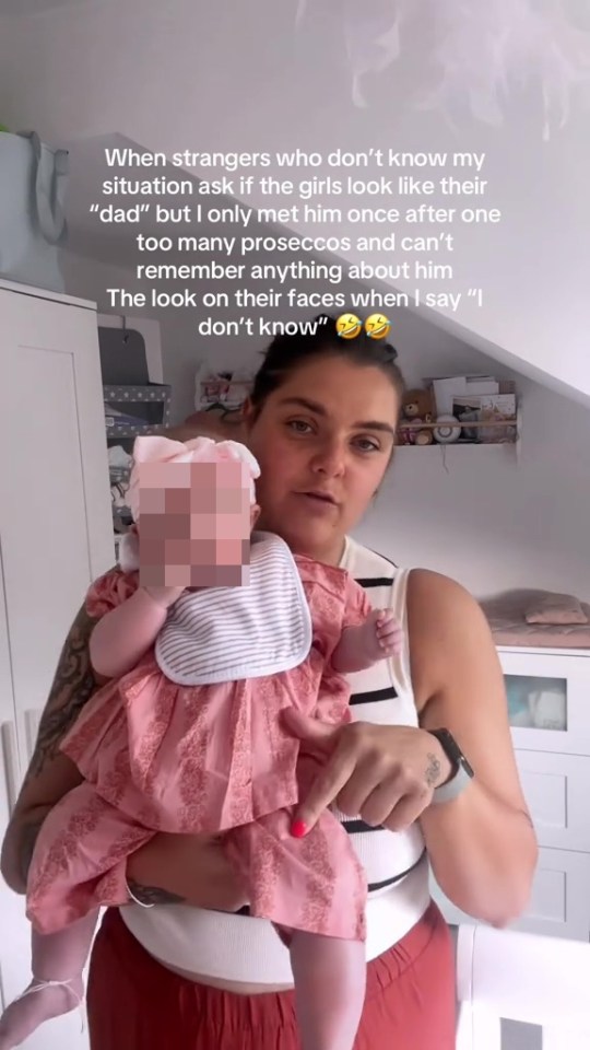 Woman holding twin infants, unsure if they resemble their father.