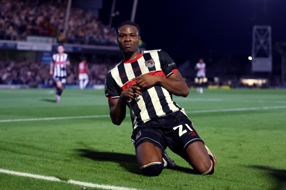 Soccer player scoring a goal.