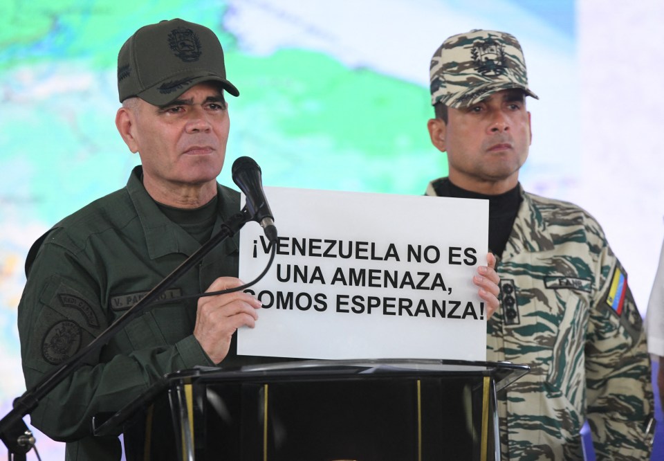 Venezuela's Defense Minister Vladimir Padrino Lopez holds a sign that reads "Venezuela is not a threat, we are hope."